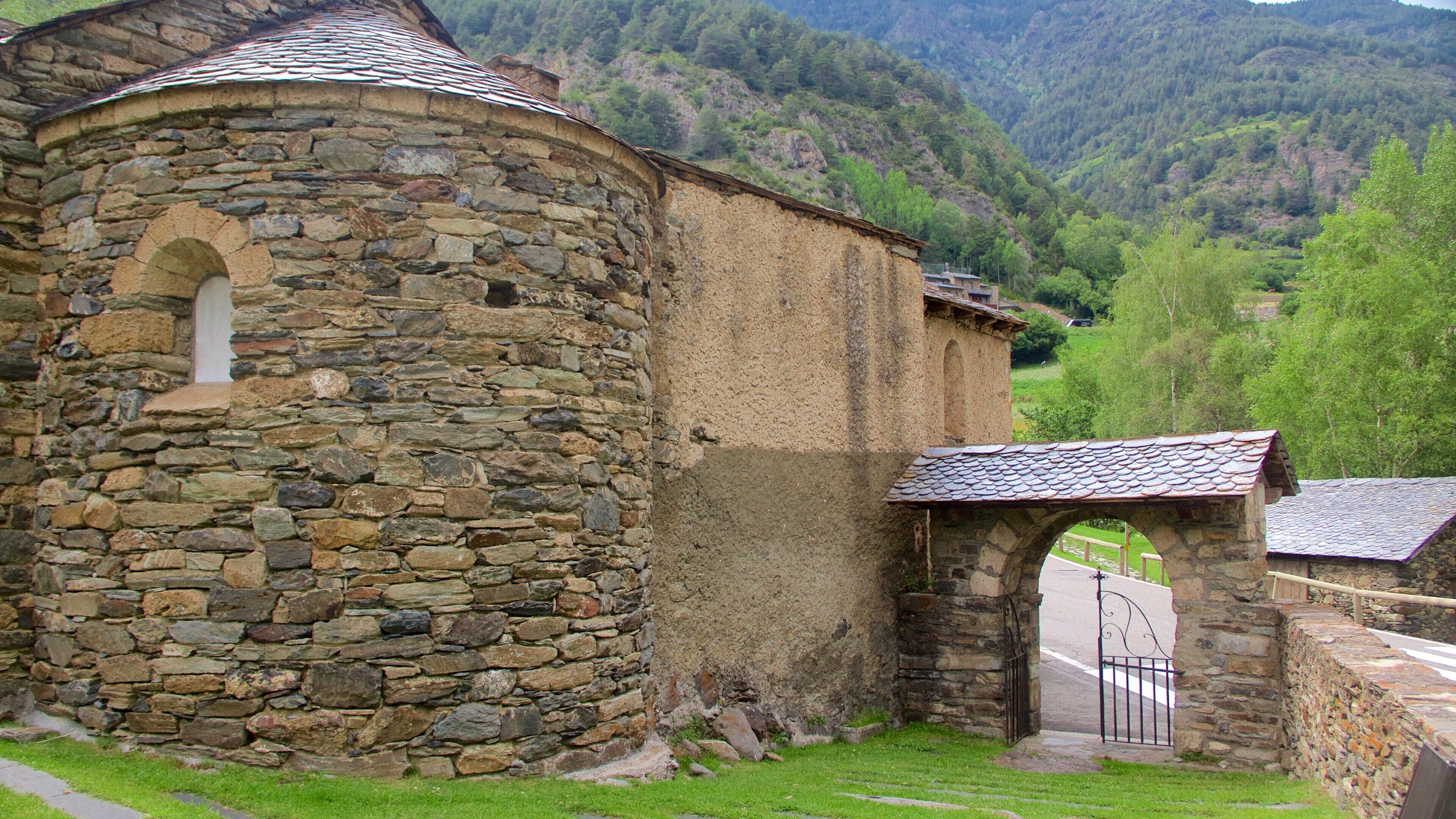 A stone building with a rounded tower and a small arched entrance.