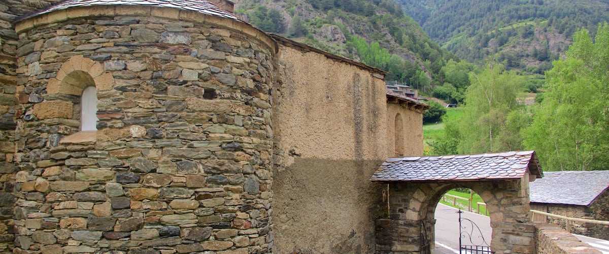 A stone building with a rounded tower and a small arched entrance.