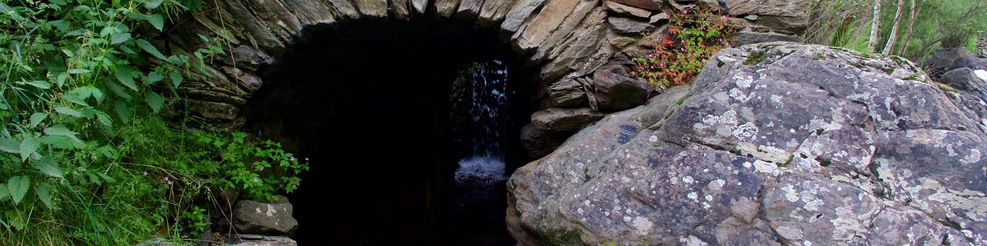 La Cortinada which includes a river or creek and caves