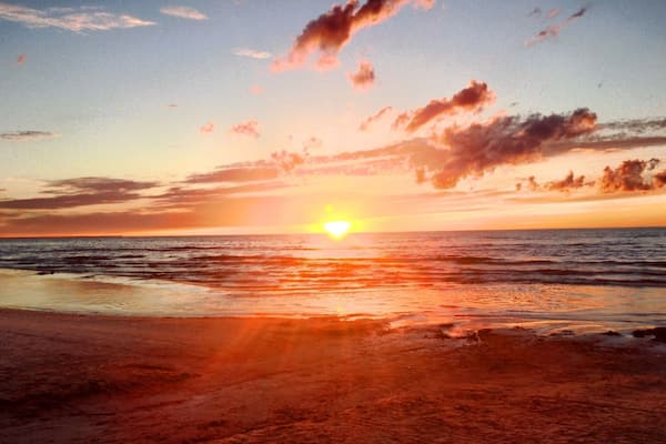 Sunset at the beach in Jƫrmala, Latvia. Take the train from Riga, which takes around 30 minutes.
It's fairly touristy, so the surrounding bars and restaurants are fairly touristy, however it's still an excellent day trip from Riga.