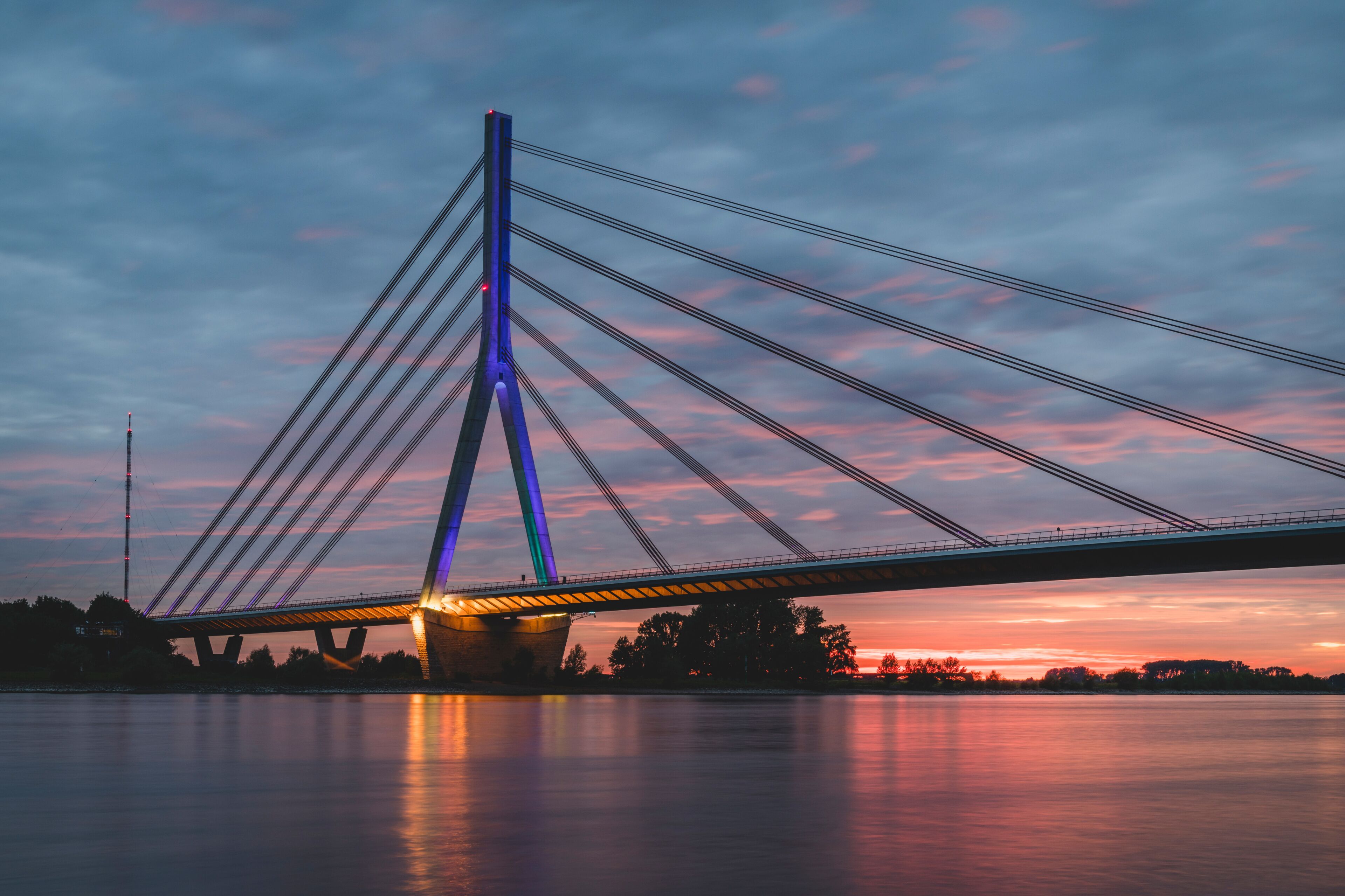 Germany, North Rhine-Westphalia, Wesel, Niederrheinbrucke Wesel bridge at cloudy sunset