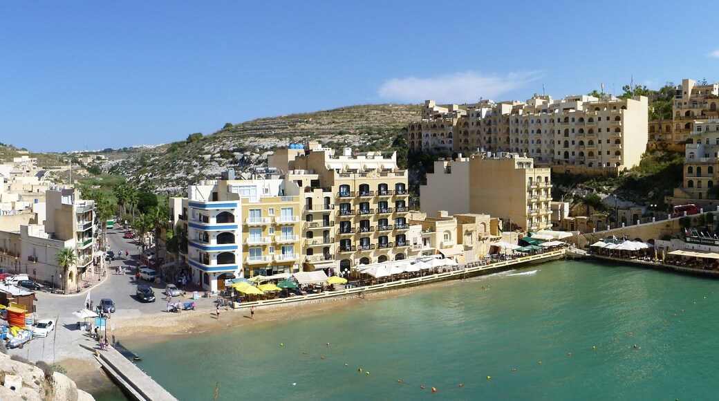 Panorama of the inner part of Xlendi bay with the beach and many restaurants at the shore line