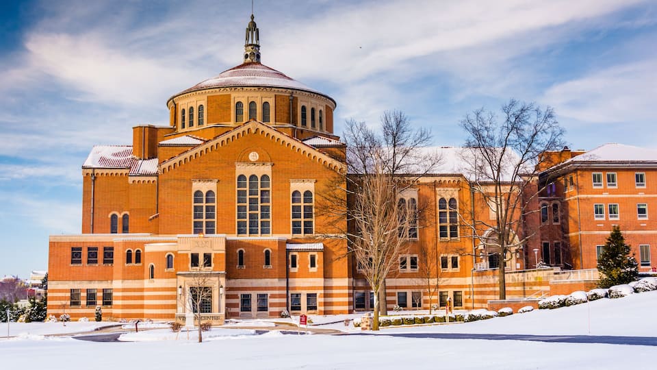 A large brick building with a dome and arched windows.