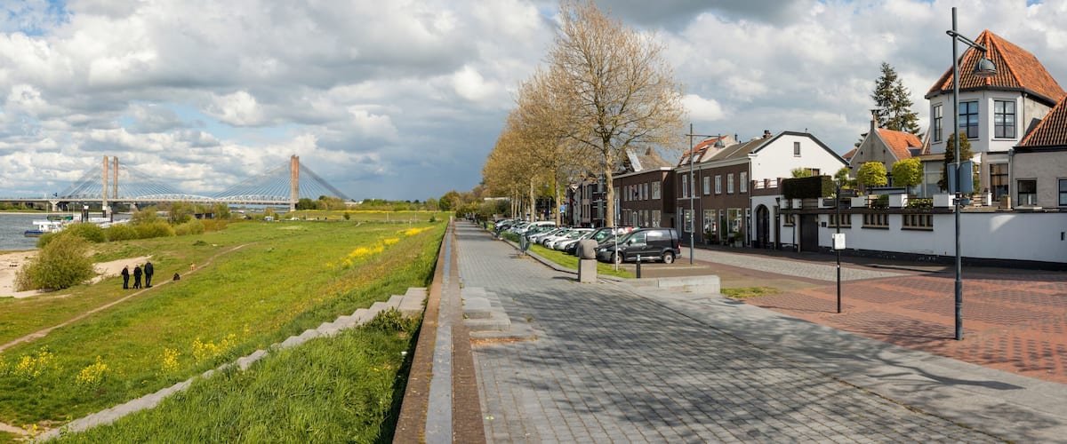 Panoramic view on the riverfront of Zaltbommel, Gelderland, with in the background the famous Martinus Nijhoff suspension bridge crossing the river Waal.