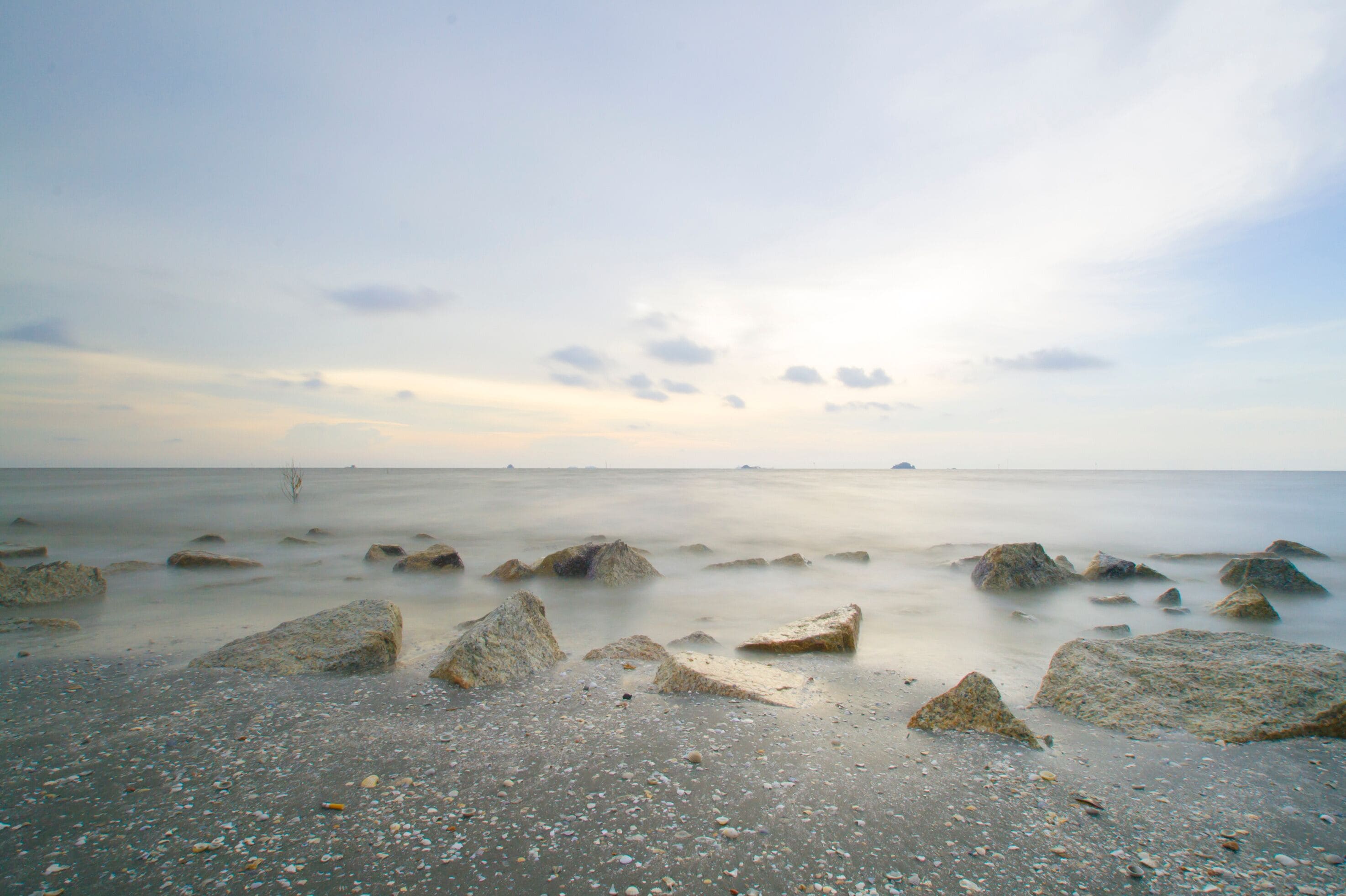 Scenery of sunset captured at Pantai Remis, Selangor, Malaysia. The motion of cloud and water is due to long exposure effect. Low light