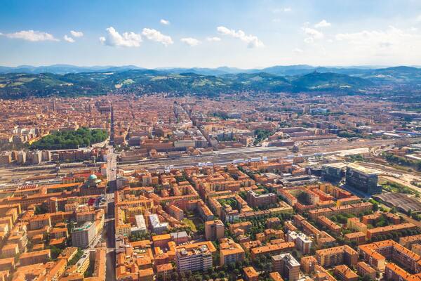 Cityscape of Bologna city, Italy, from aereal view. Famous landmarks: Central train station, the Two Towers, the Seven Churches.
