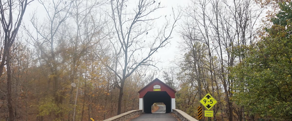 A covered bridge with a height restriction sign of 9-5 feet.