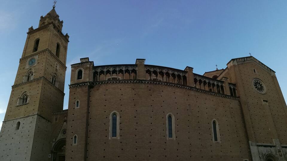 A historic church with a prominent bell tower and a circular central section.