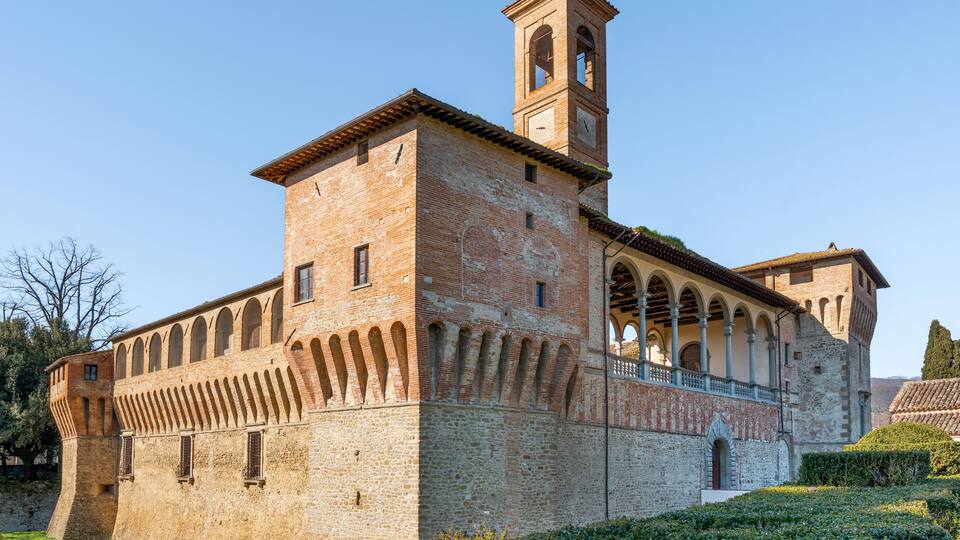 A historic building with a bell tower and arched windows.