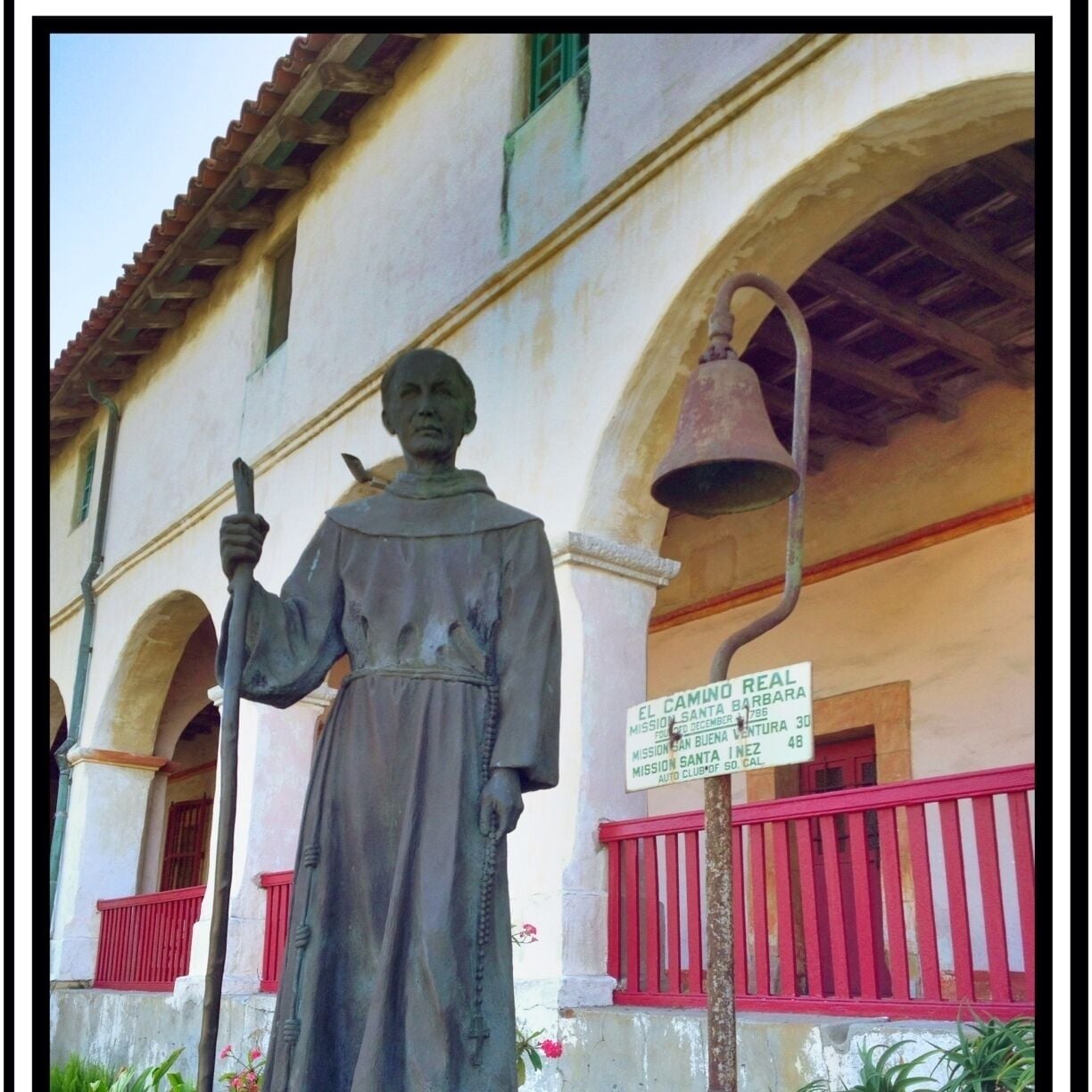 Statue of Father Junipero Serra and an El Camino Real road market, outside the Mission.