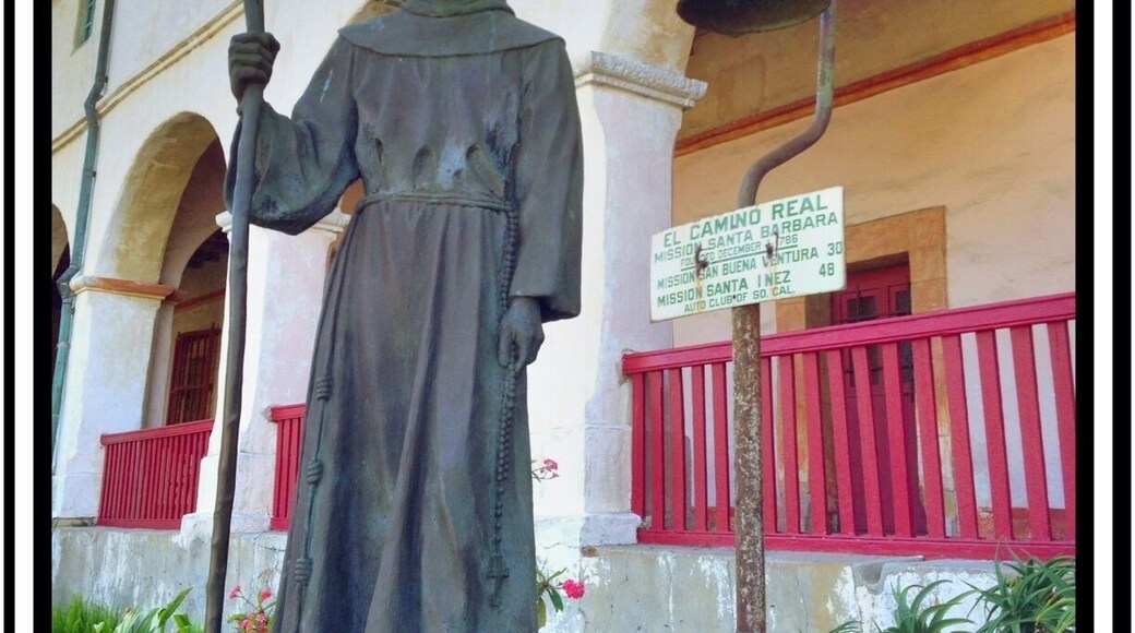 Statue of Father Junipero Serra and an El Camino Real road market, outside the Mission.