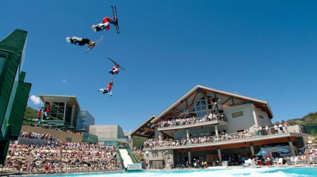 Park City featuring a sporting event and performance art as well as a large group of people