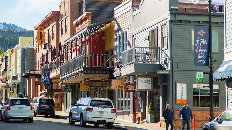 A street lined with colorful buildings, including a bakery and a furniture store.