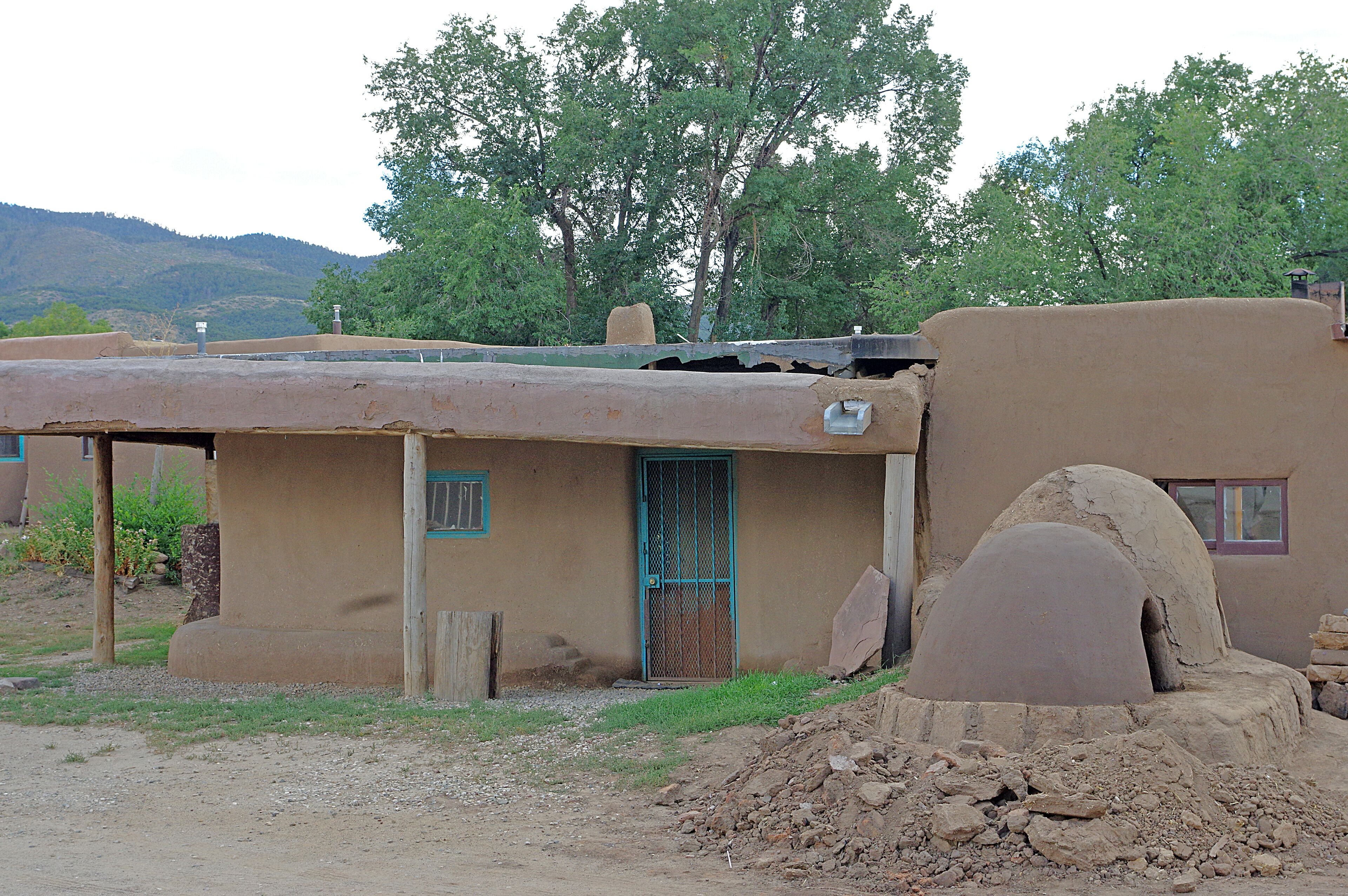 Taos Pueblo (or Pueblo de Taos) is an ancient Pueblo belonging to a Taos-speaking (Tiwa)Native American tribe of Puebloan people,. It lies about 1 mile (1.6 km) north of the modern city of Toas, New Mexico. The pueblos are considered to be one of the oldest continuously inhabited communities in the United States. This has been designated a UNESCO World Heritage Site.