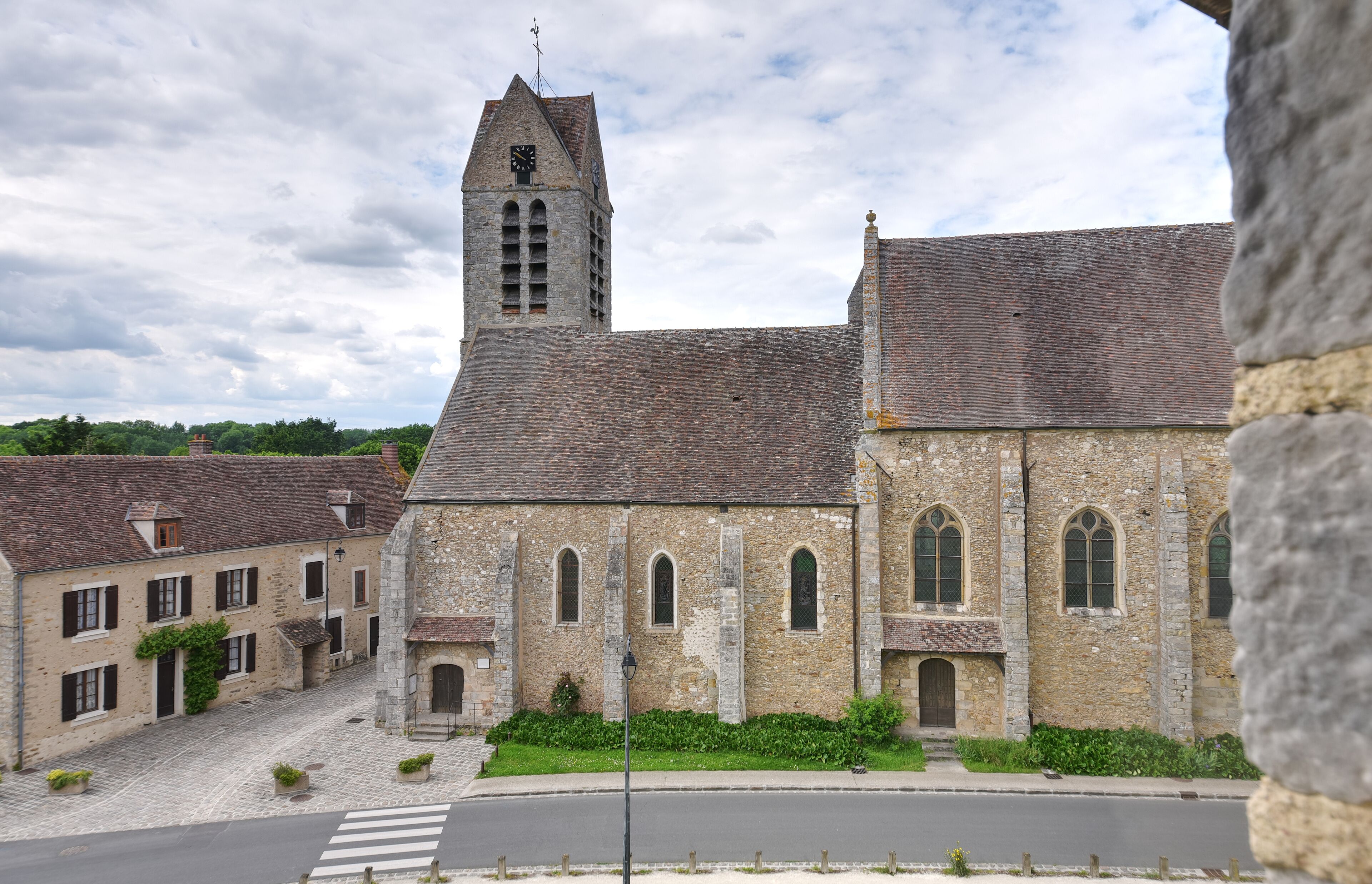 A historic stone church with a bell tower and arched windows.