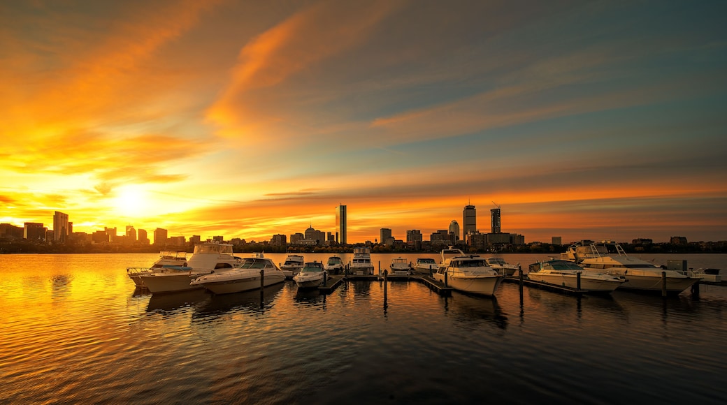 Sunrise over Boston city with boat and harbor