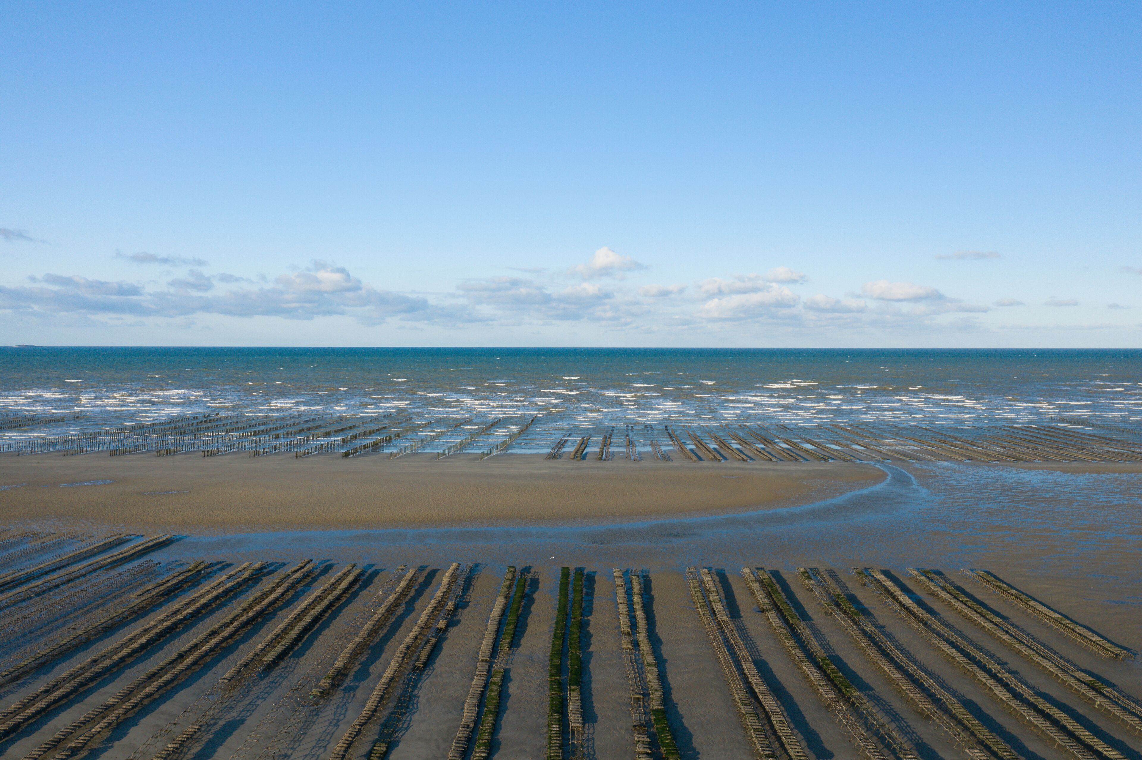 A beach with wooden structures and a sandy shoreline.