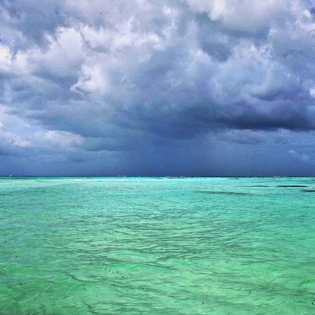 Storm clouds on the horizon at the Nylon Pool in Tobago.  It got its name because of the crystal clear water, but legend has it that bathing there makes you younger.  It's an amazing sandbar where you can wade in the middle of the ocean.  You can catch a tour boat there from Pigeon Point or Crown Point in Tobago.
#blue