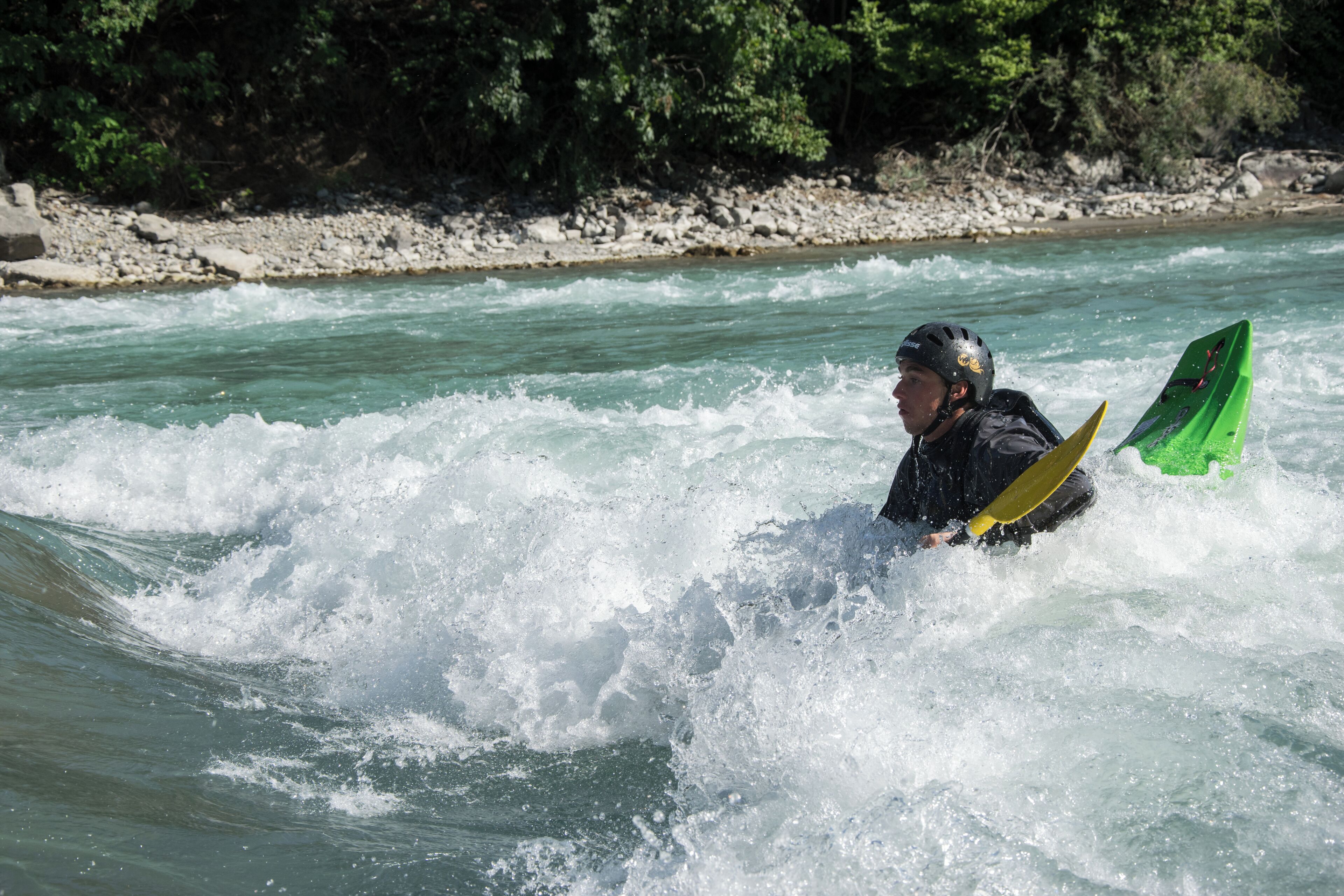 Kayaker playboating at the wave called la Clapière, at Embrun on the Durance river (France).
