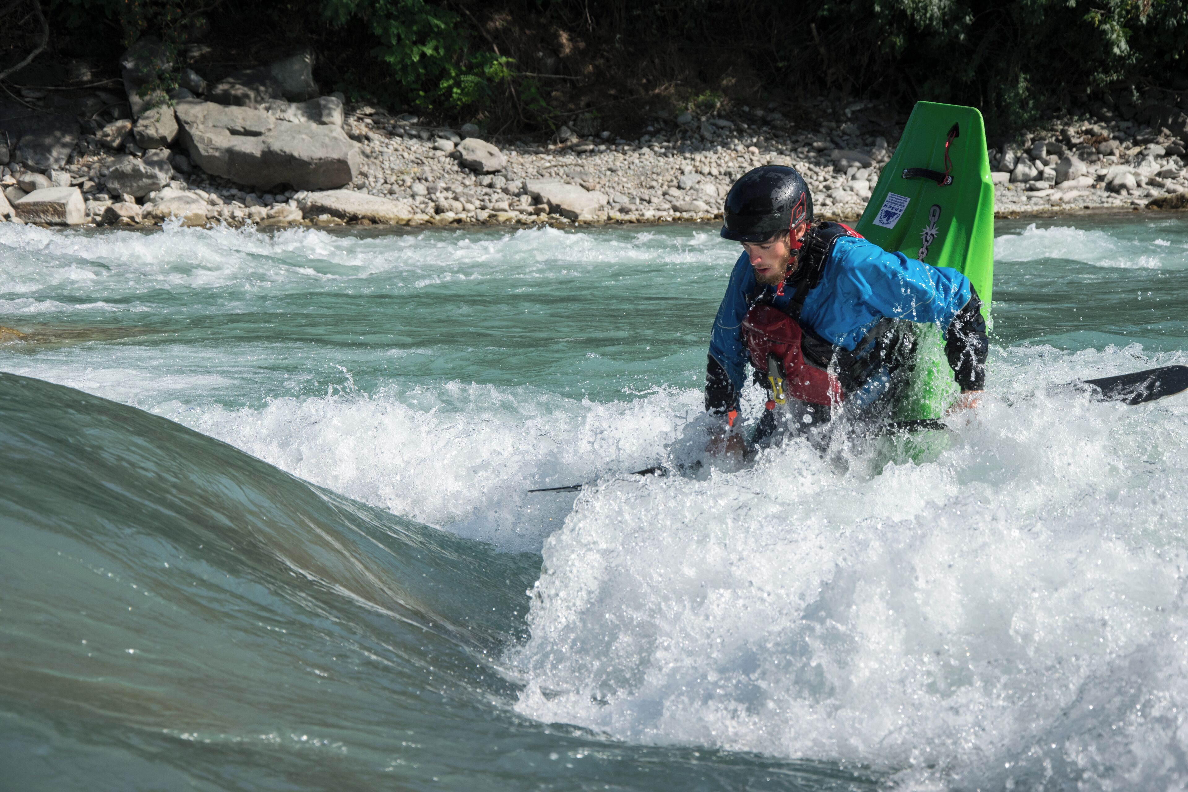 Kayaker playboating at the wave called la Clapière, at Embrun on the Durance river (France).