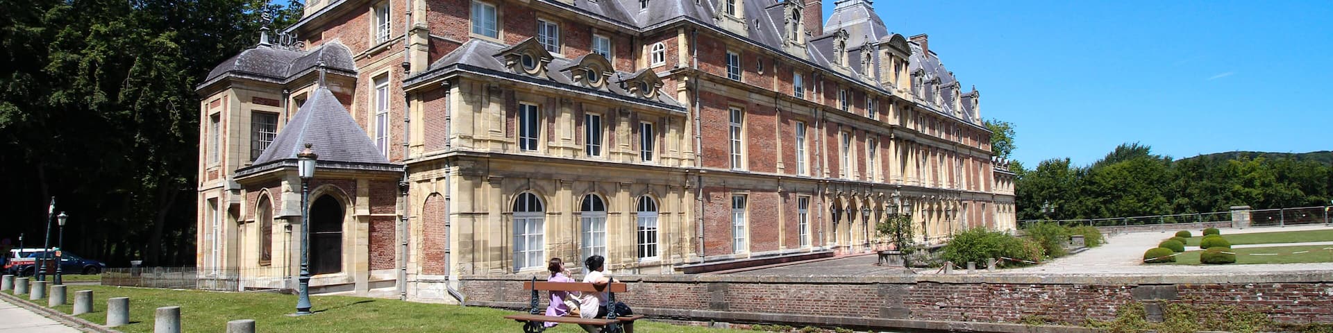A historic building with multiple gables and a prominent chimney.