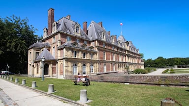 A historic building with multiple gables and a prominent chimney.