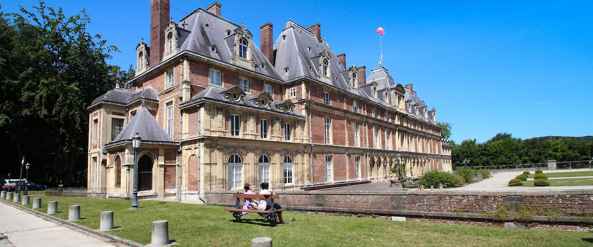 A historic building with multiple gables and a prominent chimney.