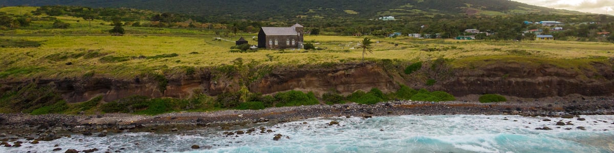 St. Kitts which includes rocky coastline, general coastal views and a sunset