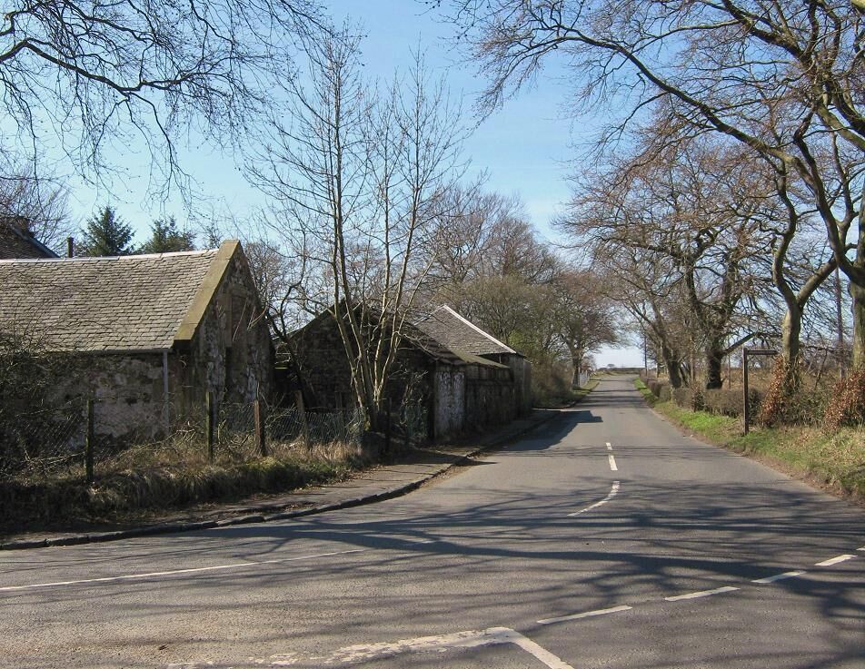 Approaching Meadowhead Meadowhead is on the left. The sign on the right is for Drumshangie Woodland Walk. There really isn't much to photograph in this grid square unless you like former opencast mines and housing estates.
