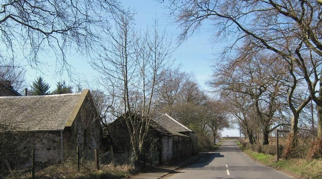 Approaching Meadowhead Meadowhead is on the left. The sign on the right is for Drumshangie Woodland Walk. There really isn't much to photograph in this grid square unless you like former opencast mines and housing estates.