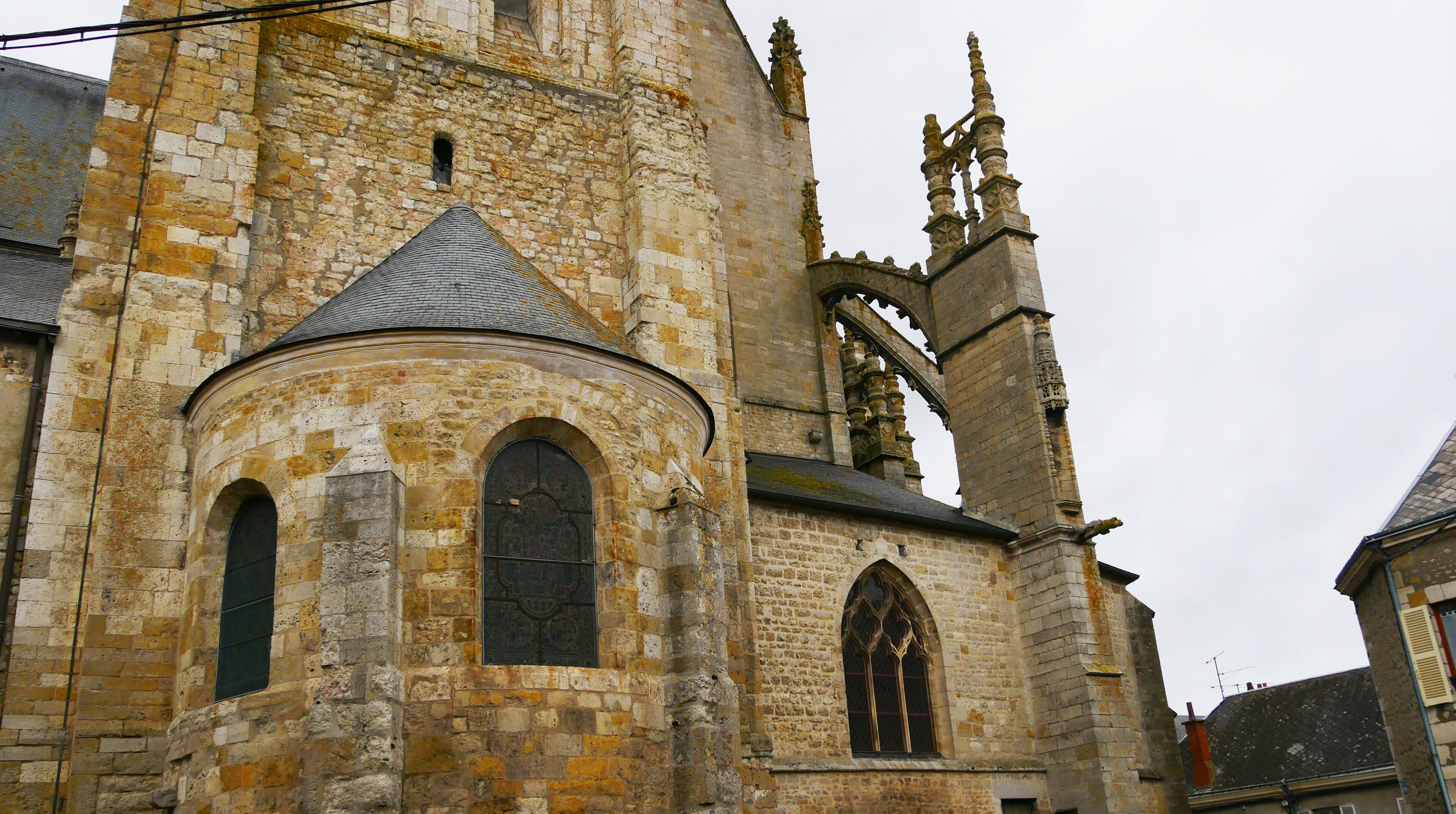 A historic stone church with arched windows and a tall bell tower.