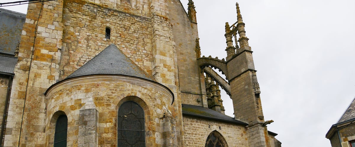 A historic stone church with arched windows and a tall bell tower.