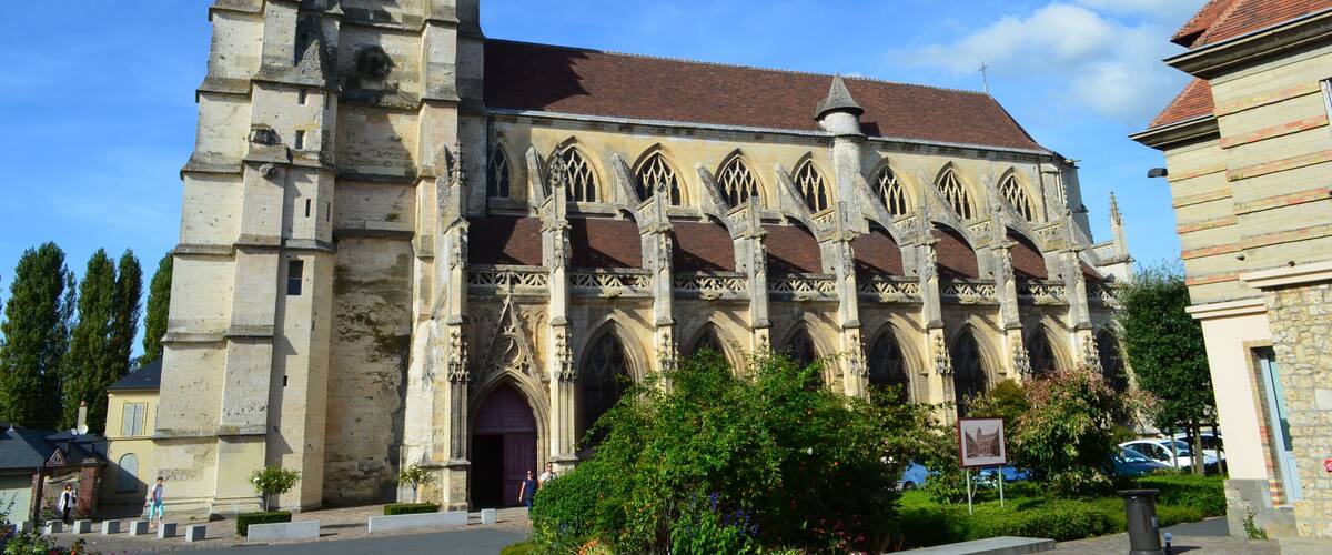 A historic church with a prominent bell tower and arched windows.