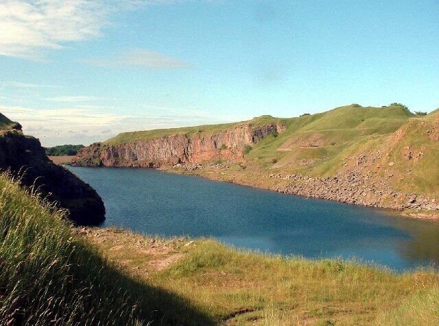 Salterhall Quarry, part of Rowrah Quarry. This limestone quarry has become water-filled since it was abandoned. Its western cliffs now provide a home for birds and its waters a final resting place for burnt-out cars.