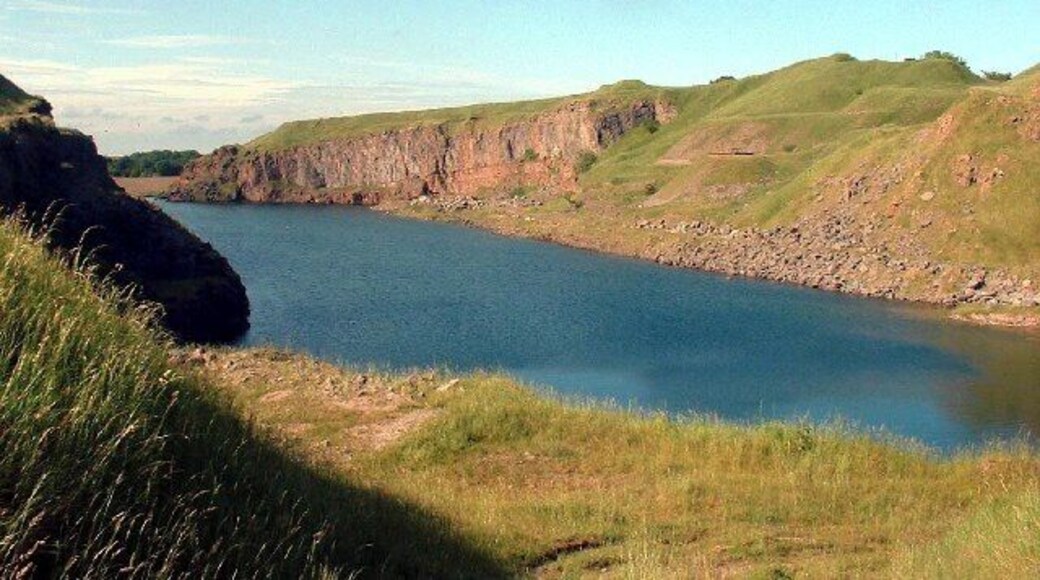 Salterhall Quarry, part of Rowrah Quarry. This limestone quarry has become water-filled since it was abandoned. Its western cliffs now provide a home for birds and its waters a final resting place for burnt-out cars.
