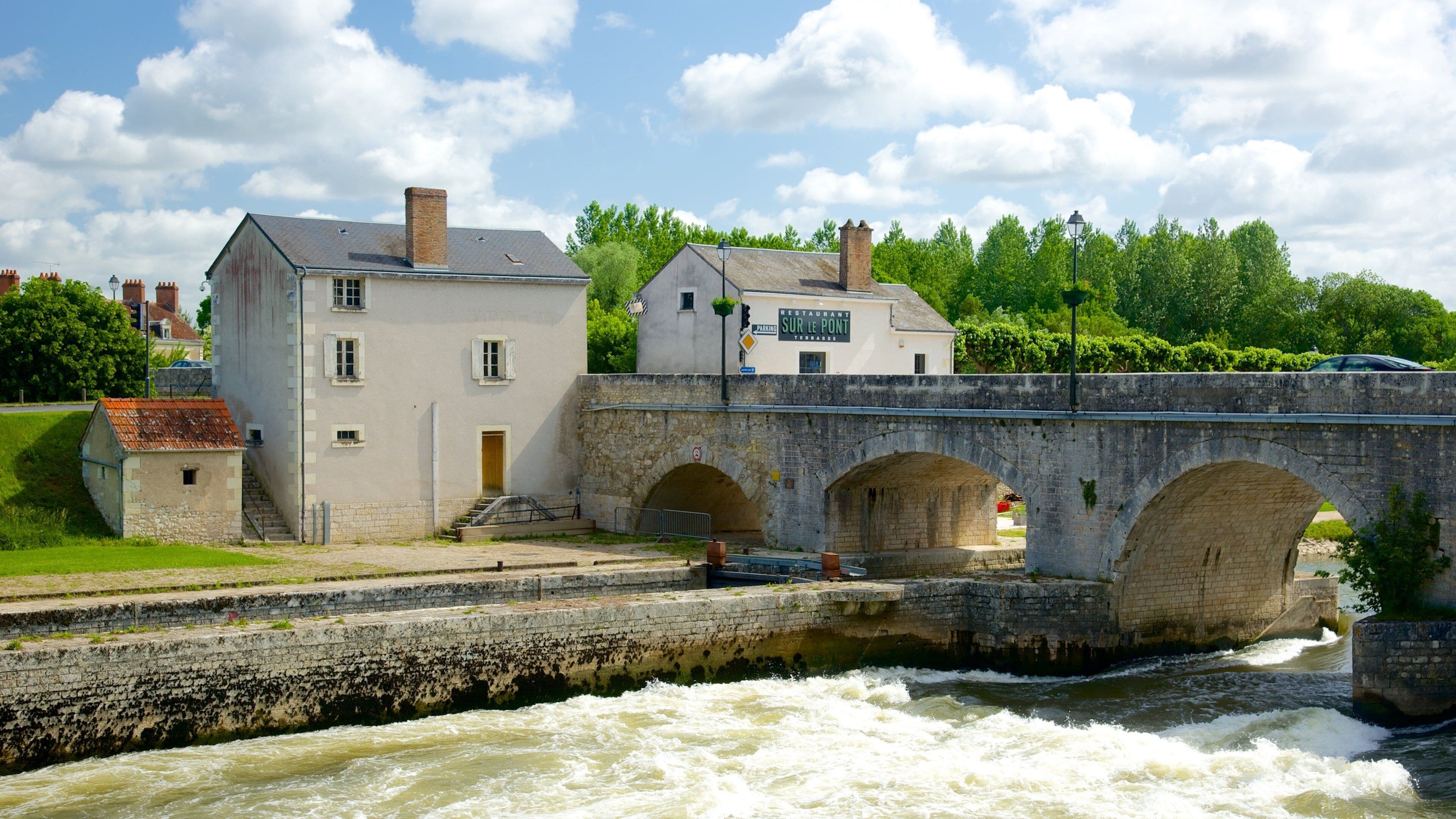 Saint-Aignan which includes a bridge and a river or creek
