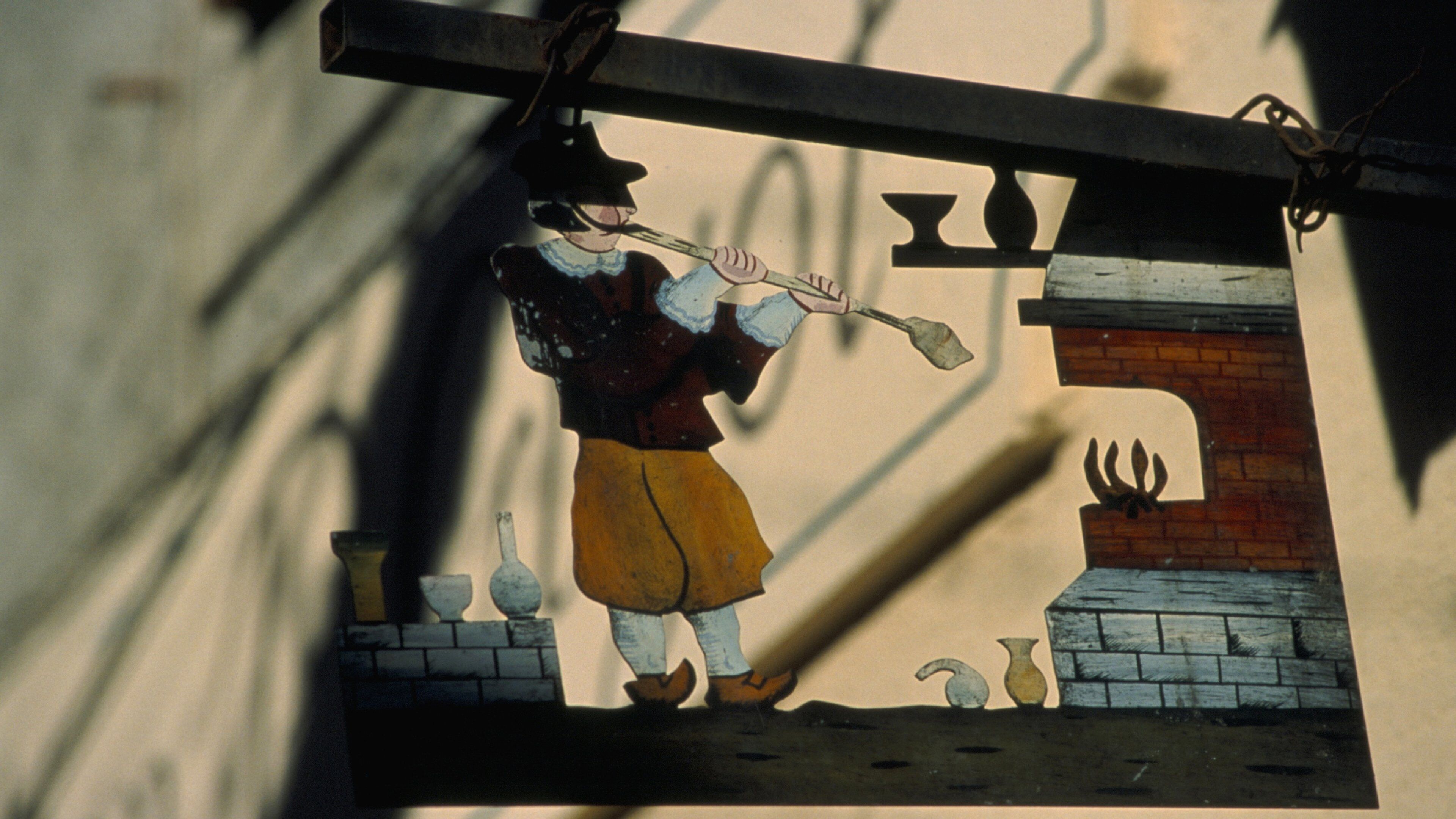 A stained glass window depicting a man playing a flute.