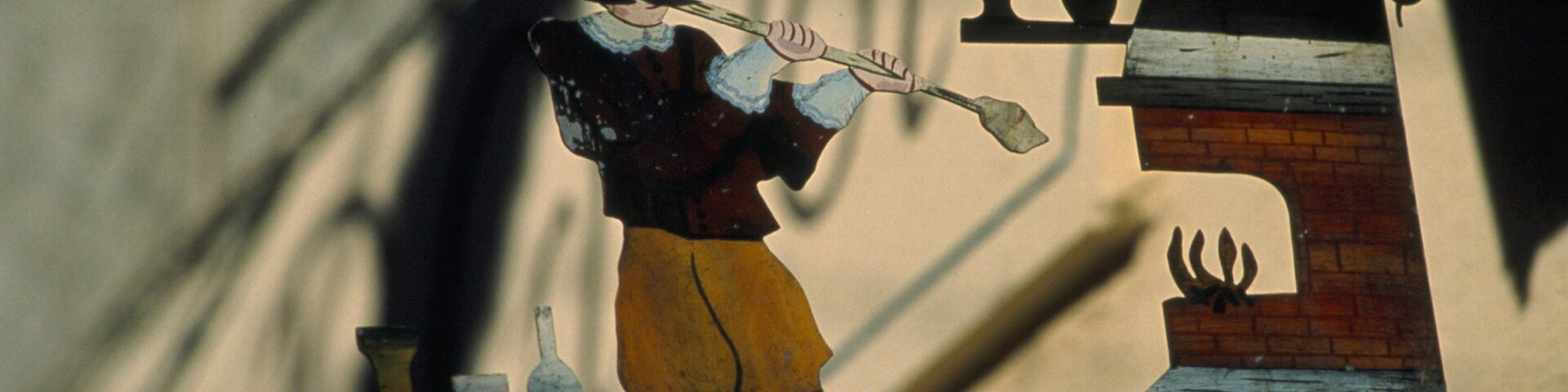 A stained glass window depicting a man playing a flute.