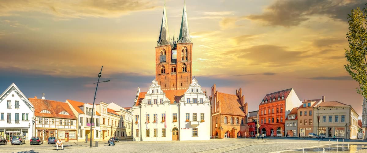 A historic church with twin spires, surrounded by traditional European architecture.