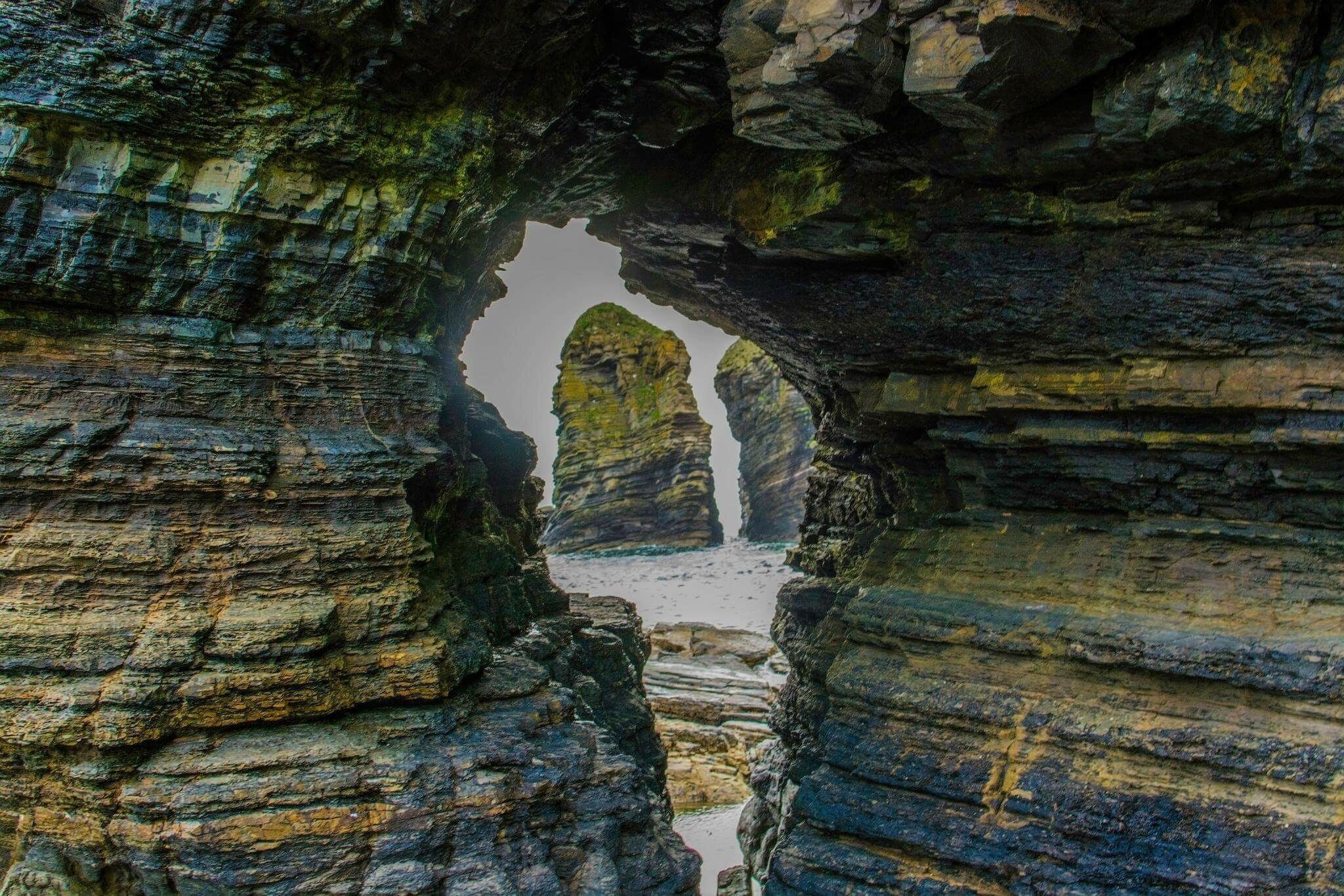 A natural rock formation with a narrow passageway and towering rock pillars.