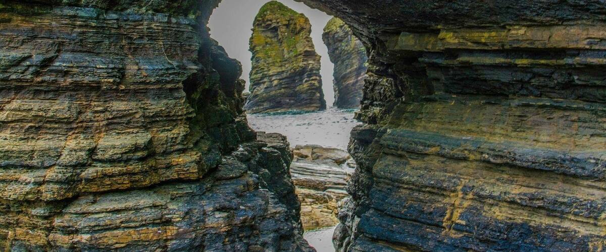 A natural rock formation with a narrow passageway and towering rock pillars.