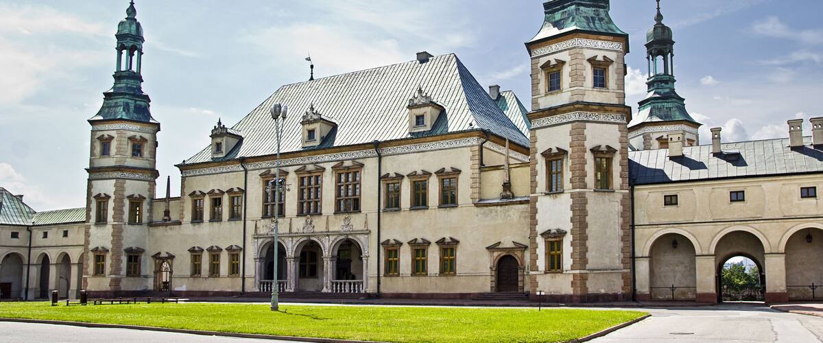 A historic building with two prominent towers and a central dome.