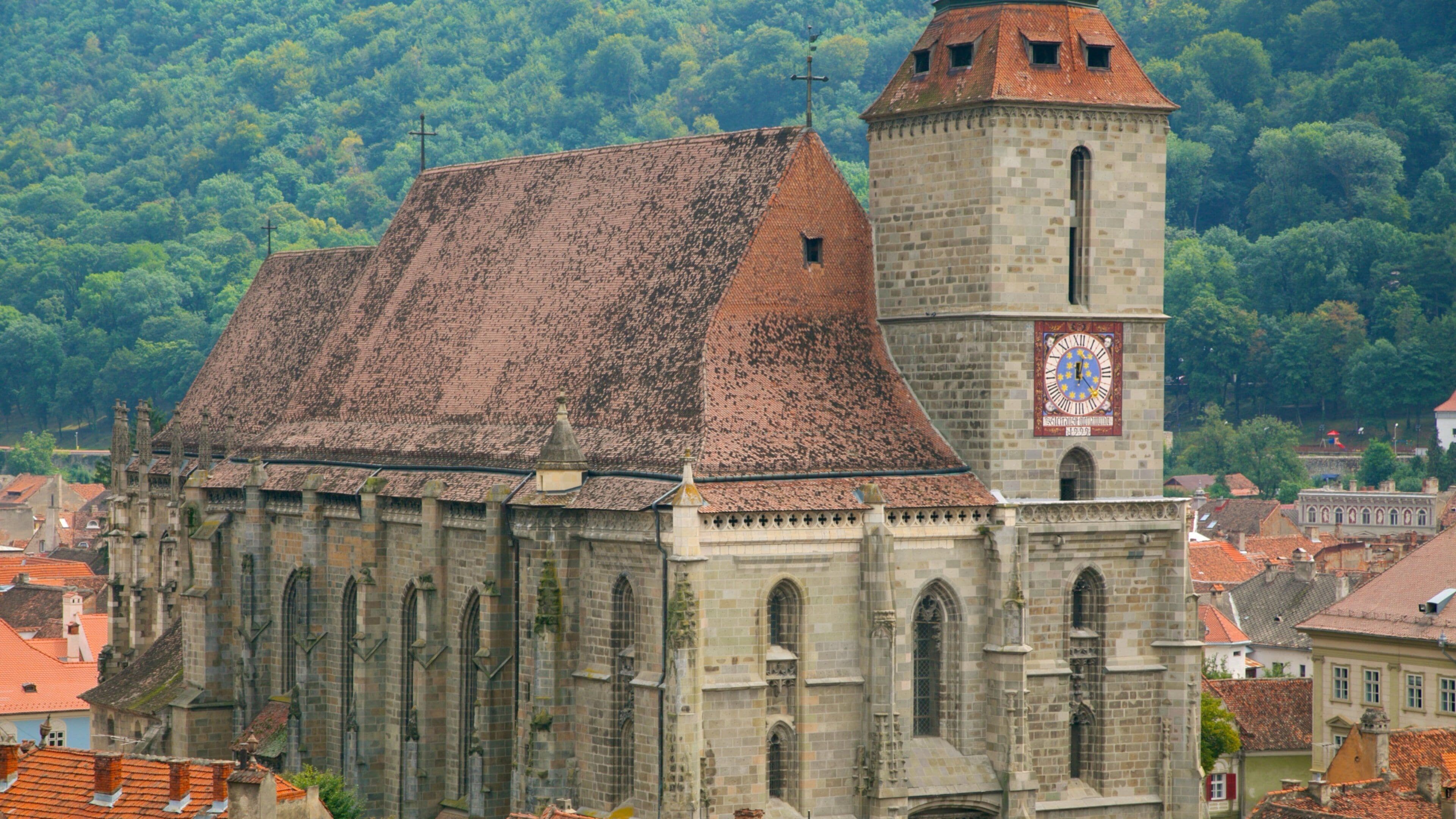 A historic church with a clock tower and a red-tiled roof.