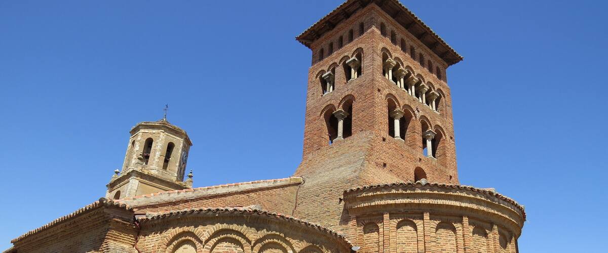A historic church with a prominent bell tower and arched windows.