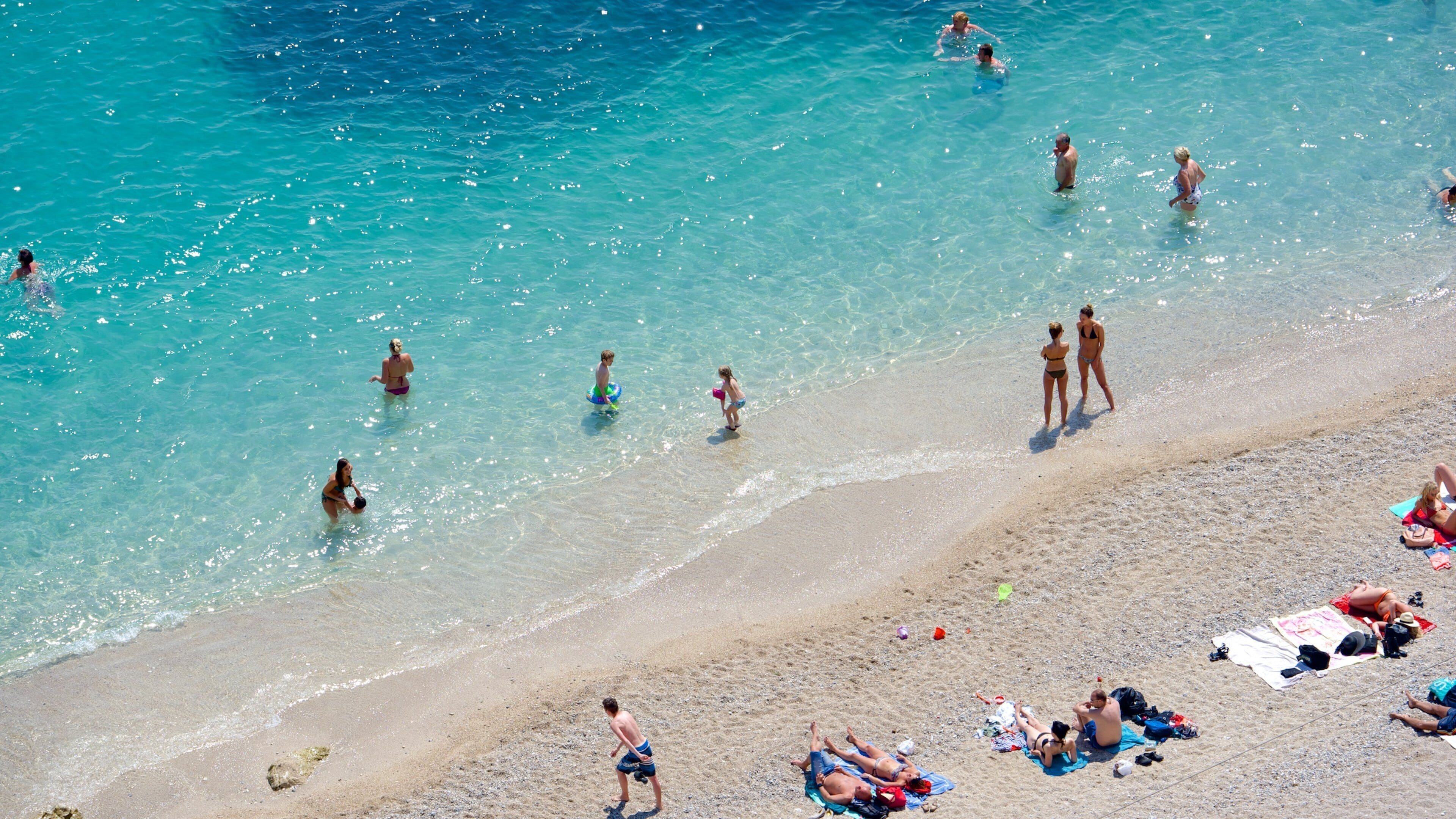French Riviera showing a beach as well as a small group of people