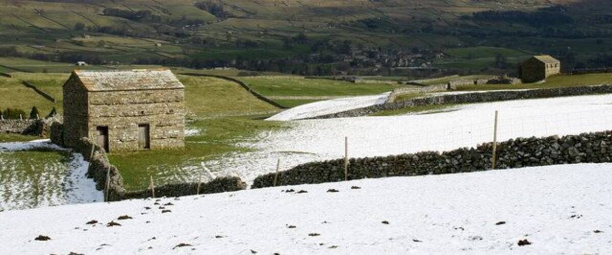 Barns above Bainbridge Snow still lying on the north facing slopes with Askrigg in the middle distance and East Bolton Moor beyond.