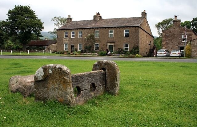 The old stocks, Bainbridge Most likely dating from the 17th century, the stone alongside is thought to have been a seat - look out for low-flying rotten vegetables!