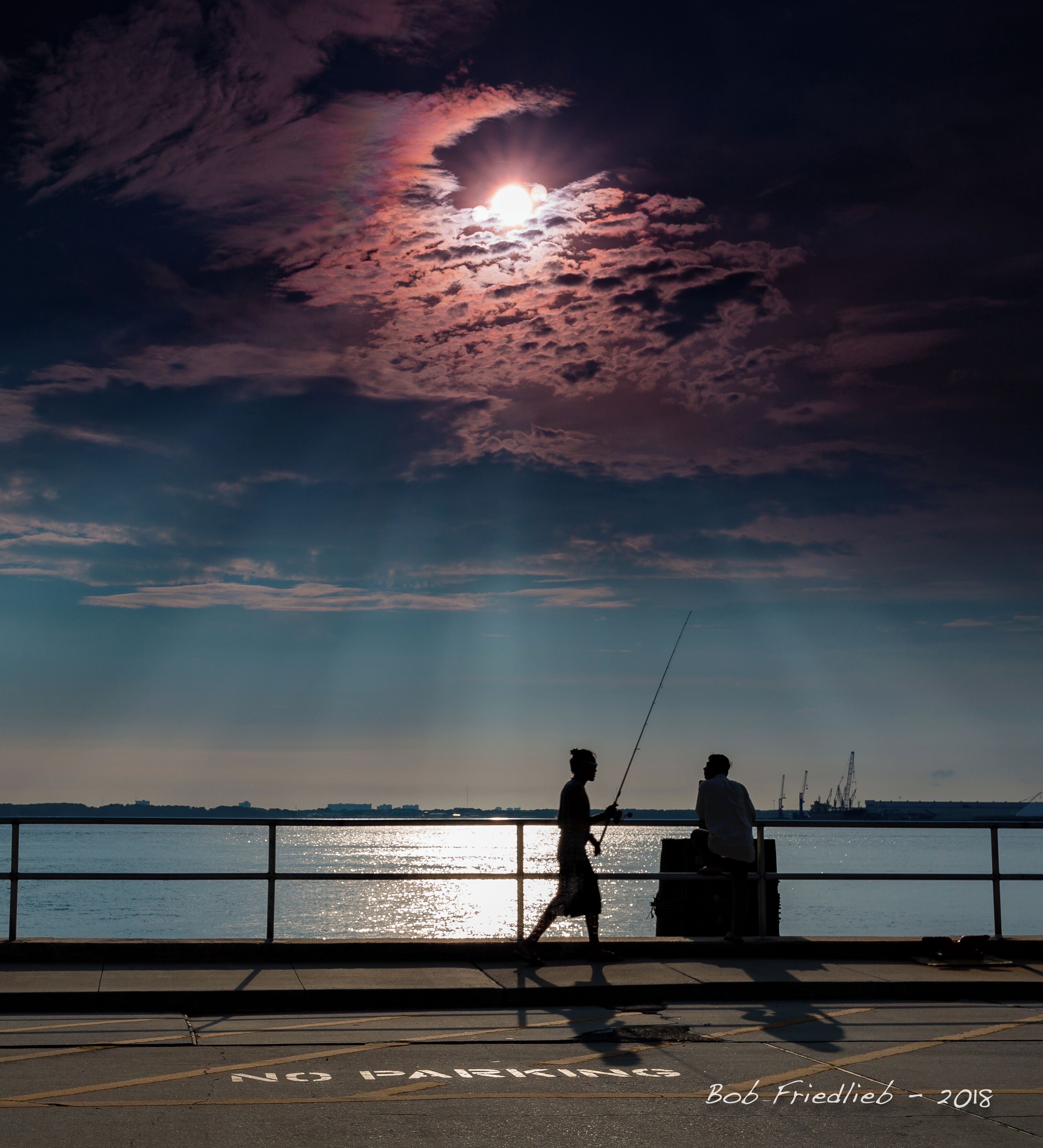 A fisherman and a searcher at the Panama City Pier at Harrison Avenue.