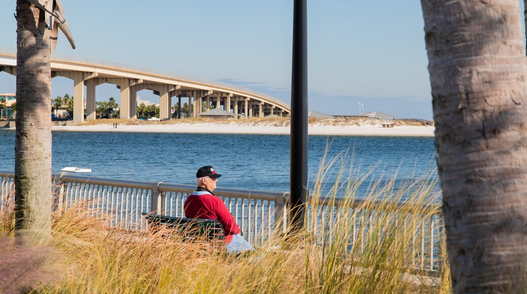 Pensacola showing a bridge and a river or creek as well as an individual male