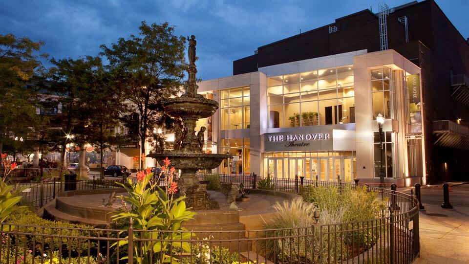 A modern building with a sign reading "THE HANOVER Theatre" and a decorative fountain in front.